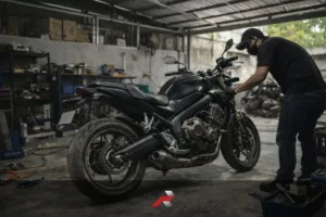 Big bike maintenance in a tropical climate Philippines garage with mechanic servicing a sport touring motorcycle inside a small workshop