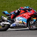 ZX Moto WSBK Motor Champion race bike leaning in high-speed corner during superbike race