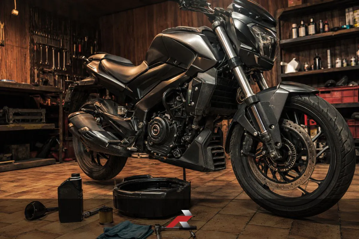 Big bike oil change service in a garage with a Dominar-style motorcycle, oil drain pan, tools, and maintenance supplies