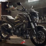 Big bike oil life article image showing a Dominar-style motorcycle inside a garage workshop with warm light and maintenance setting