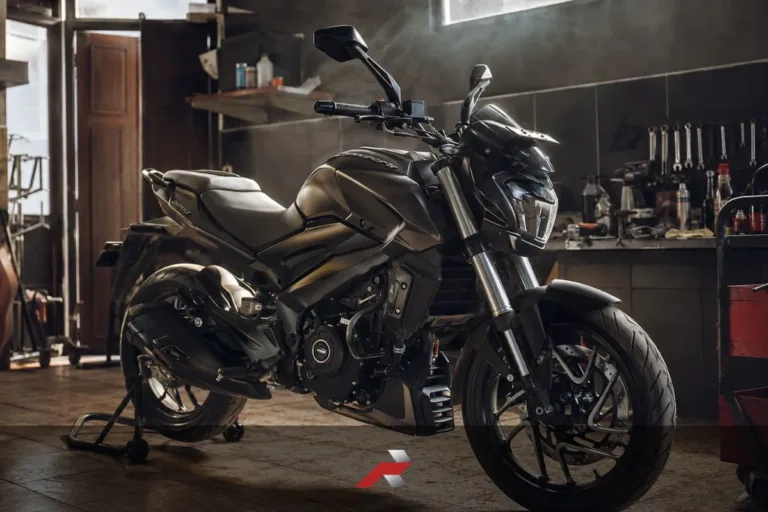 Big bike oil life article image showing a Dominar-style motorcycle inside a garage workshop with warm light and maintenance setting