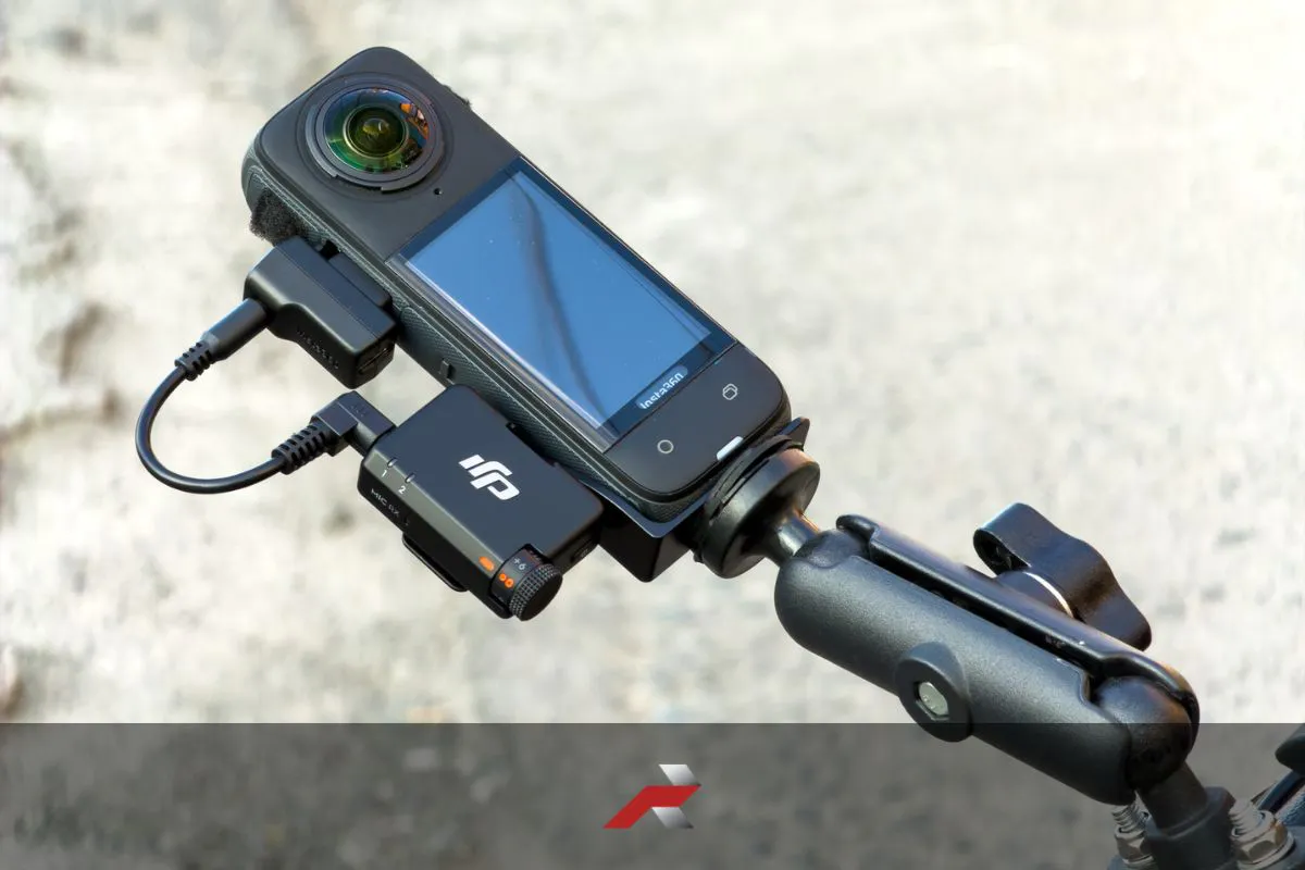 DJI Mic Mini motorcycle review setup with receiver connected to Insta360 X4 on handlebar mount