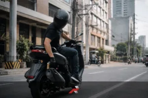 Nmax V3 Issues and Problems guide showing a scooter rider checking the rear brake during daily city riding