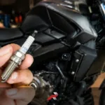 Dominar 400 spark plug replacement cost Philippines shown with NGK iridium spark plug and motorcycle background
