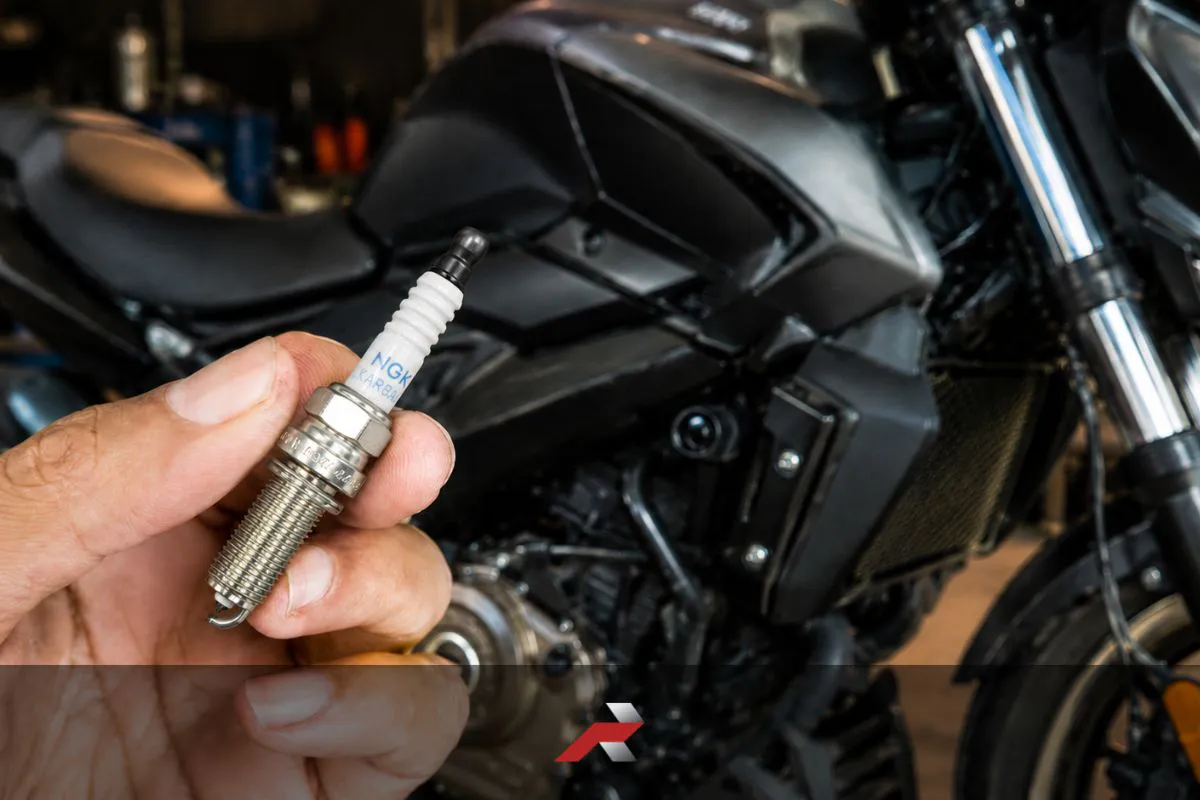Dominar 400 spark plug replacement cost Philippines shown with NGK iridium spark plug and motorcycle background